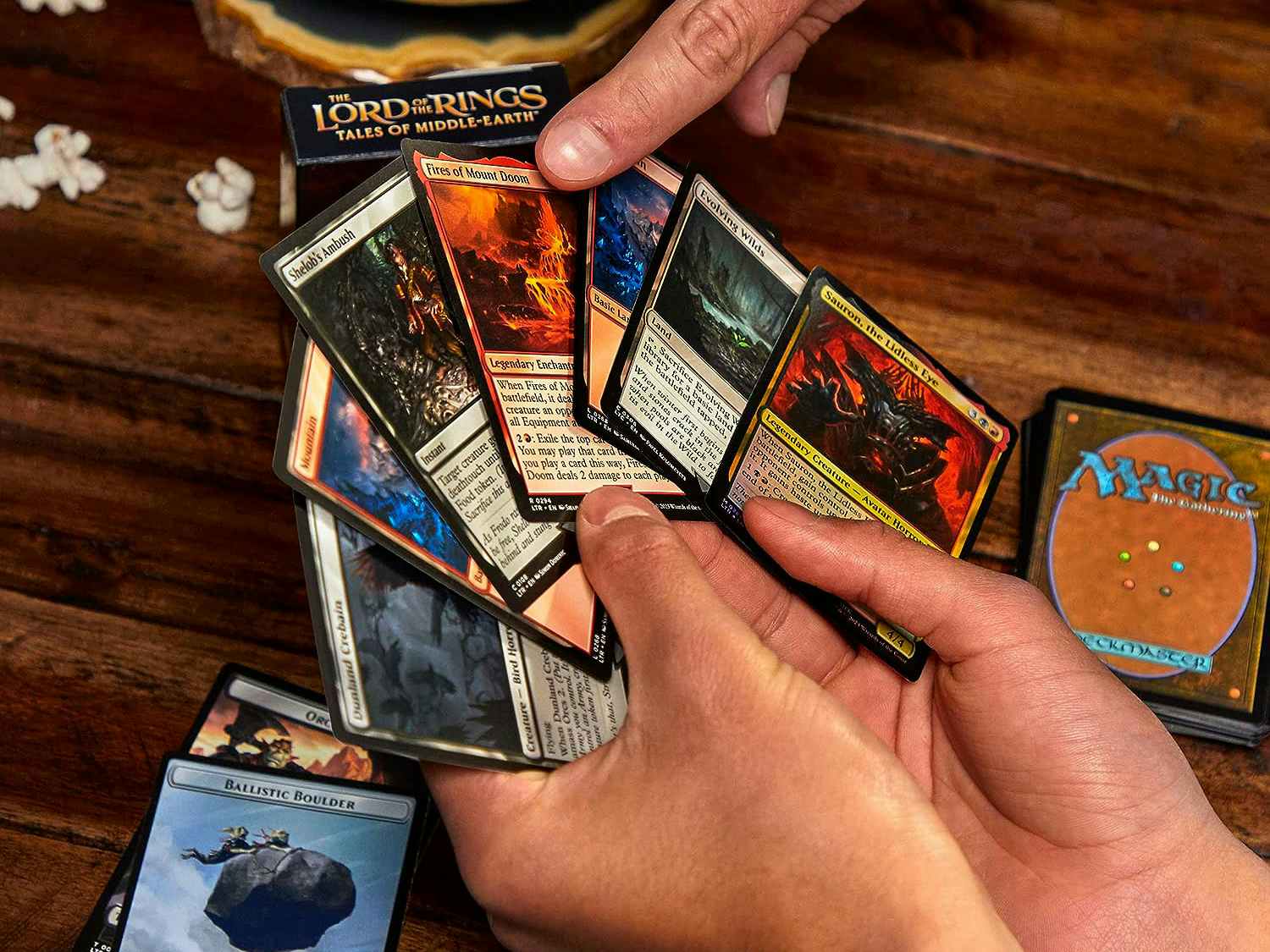someone fanning out some Lord of the Rings Magic the gathering cards