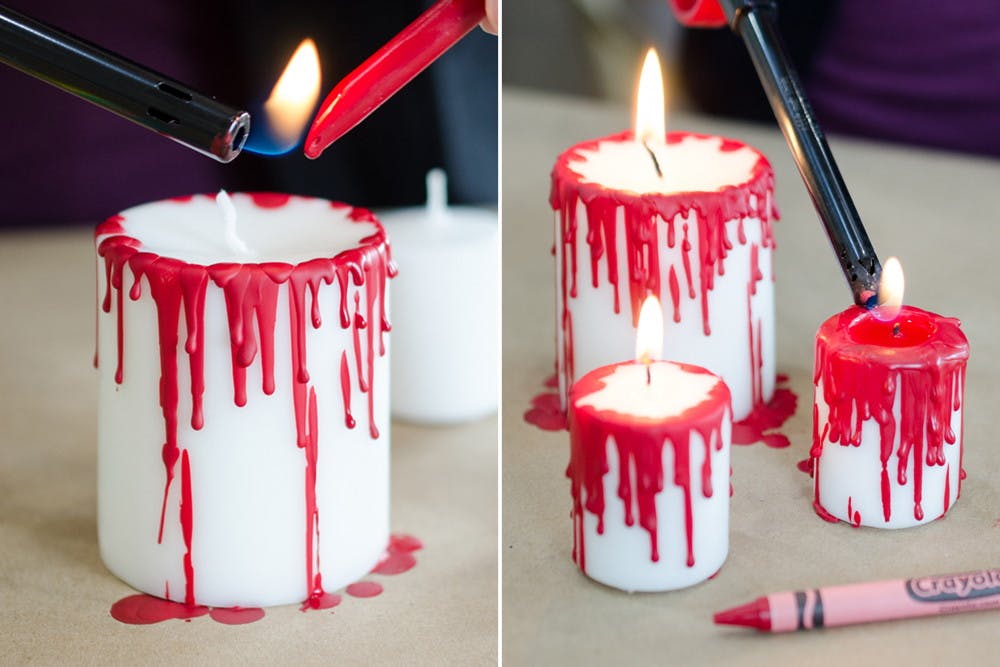 Two photos side-by-side; A person using a lighter to melt a red crayon all over the outside of a red white candle making drips down the side that look like blood. A person using a lighter to light one of the candles with crayon melted down the sides. Two other candles are already lit.
