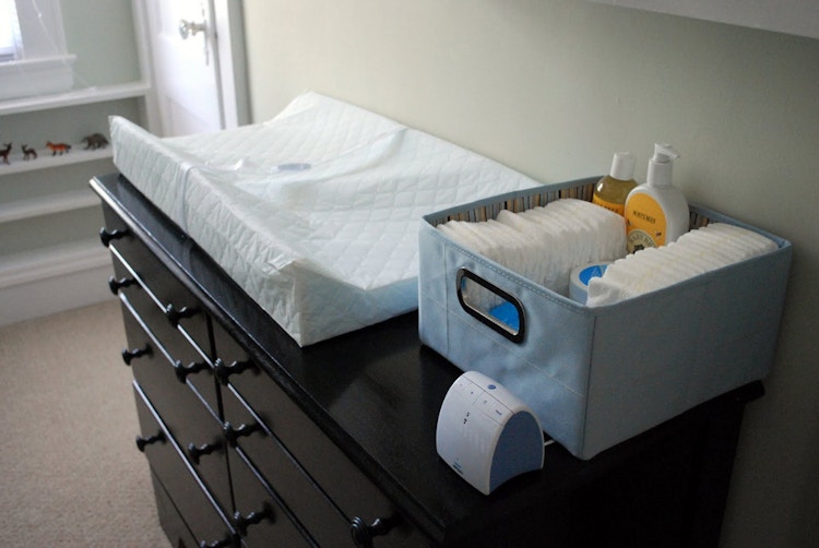 Secure a changing pad on top of a dresser instead of buying a changing table.
