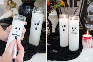 Ghost faces drawn onto the outside glass of a white pillar candle.