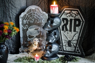 Three skulls stacked on one another making a candle holder.