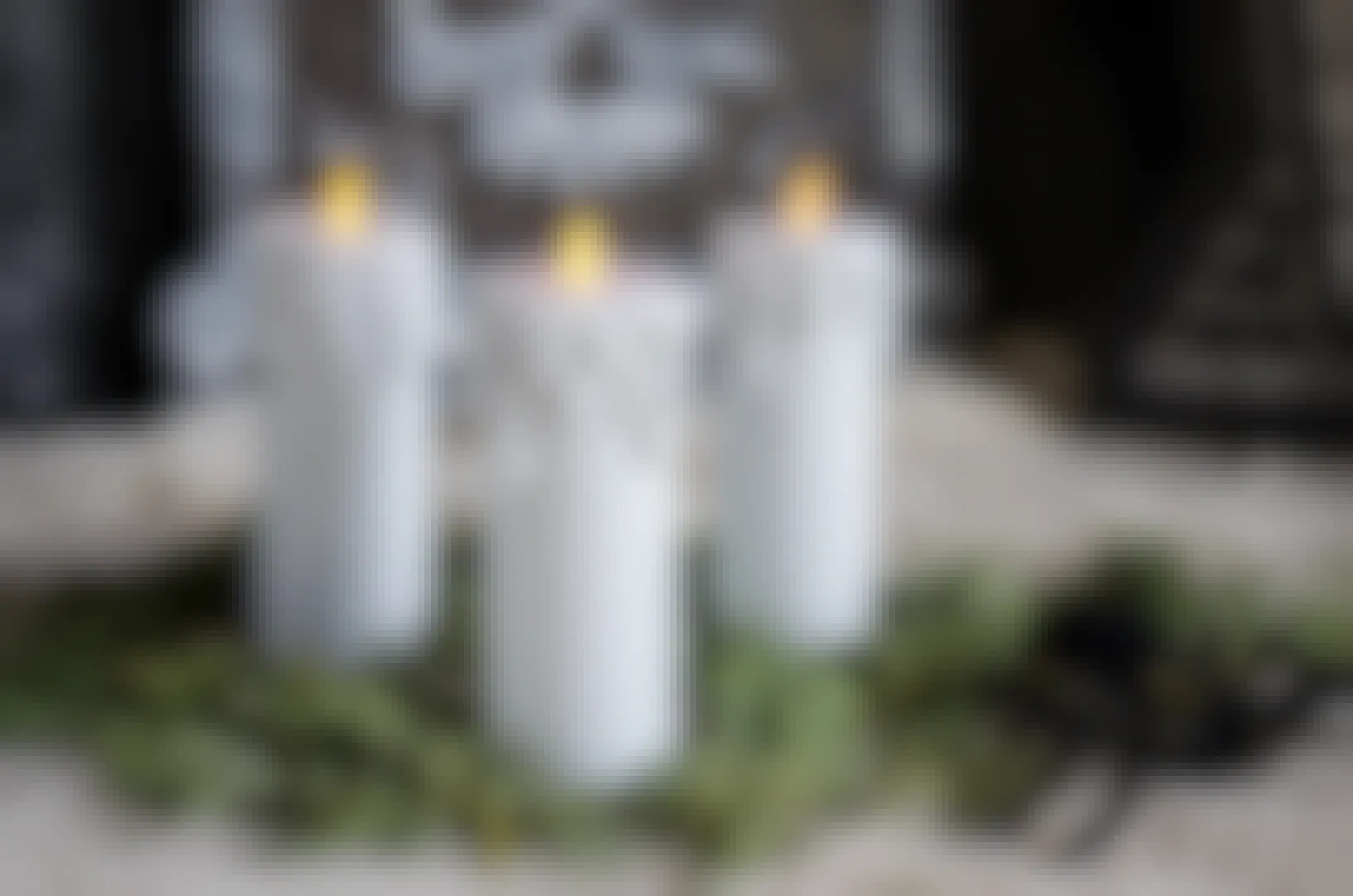 three toilet paper tubes with fake candles on top