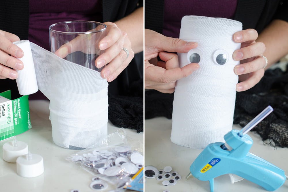 Someone wrapping a glass candle holder in gauze and applying some googly eyes to make it look like a mummy.