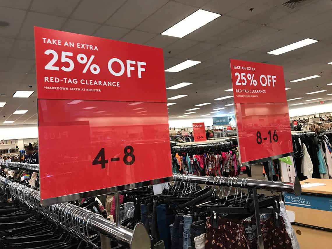 Two clothing racks with red clearance tags above them.