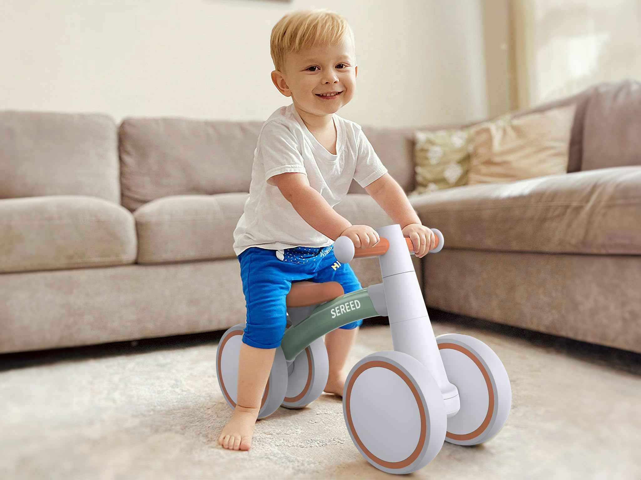 a baby sitting on a SEREED baby balance bike