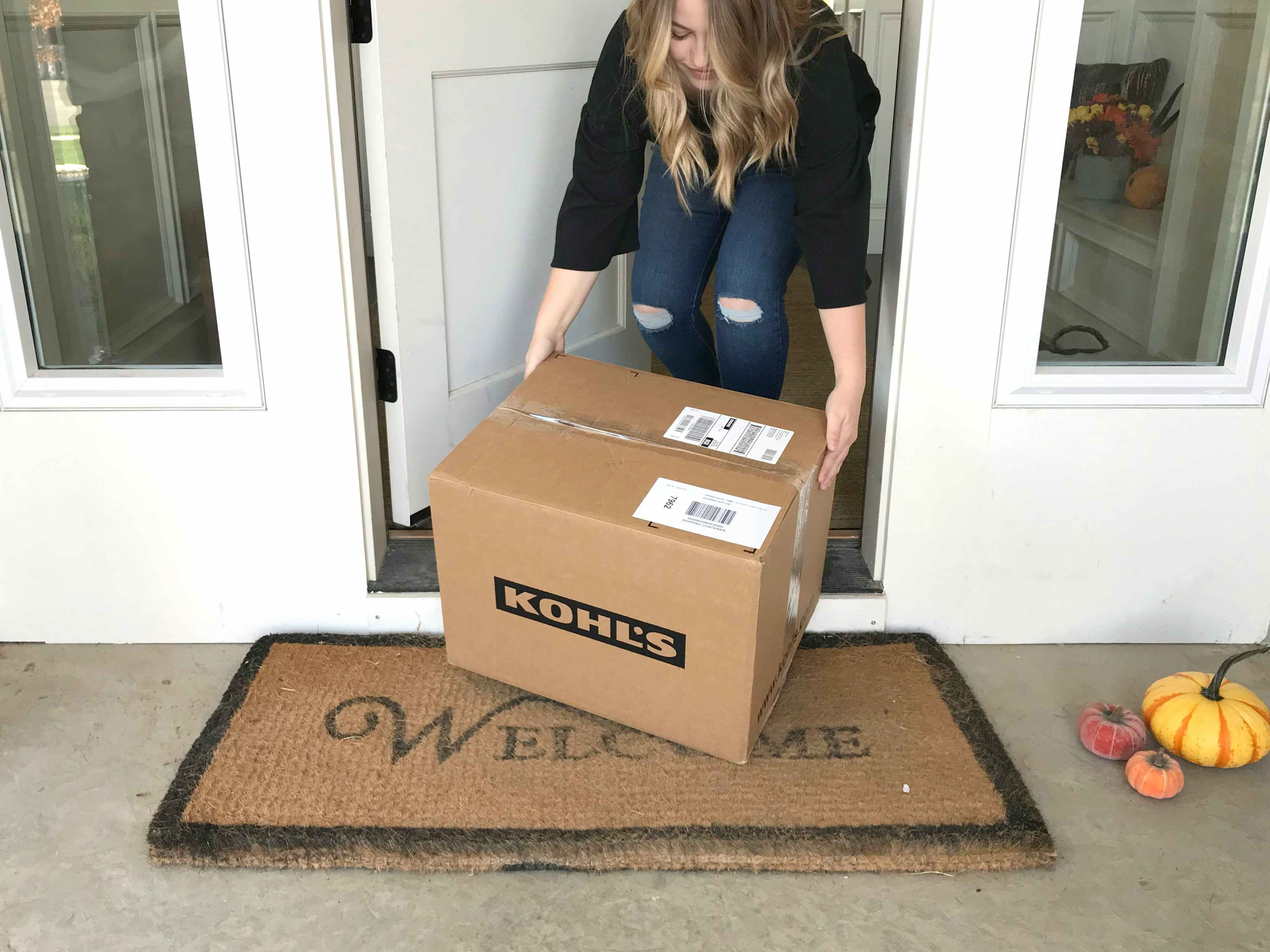 person picking up kohls delivered box from front step