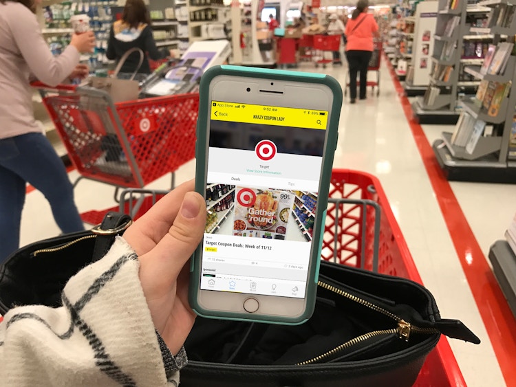 A person looking at their phone displaying the Target page of the KrazyCouponLady app.