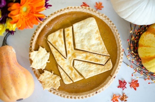 pumpkin pie with KCL icon baked into it surrounded by fall decor