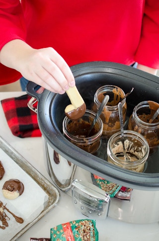 Melt chocolate and keep it melted in a slow cooker.