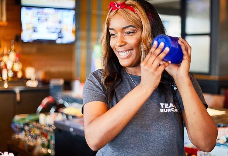a Chili's employee mixing a drink at the bar