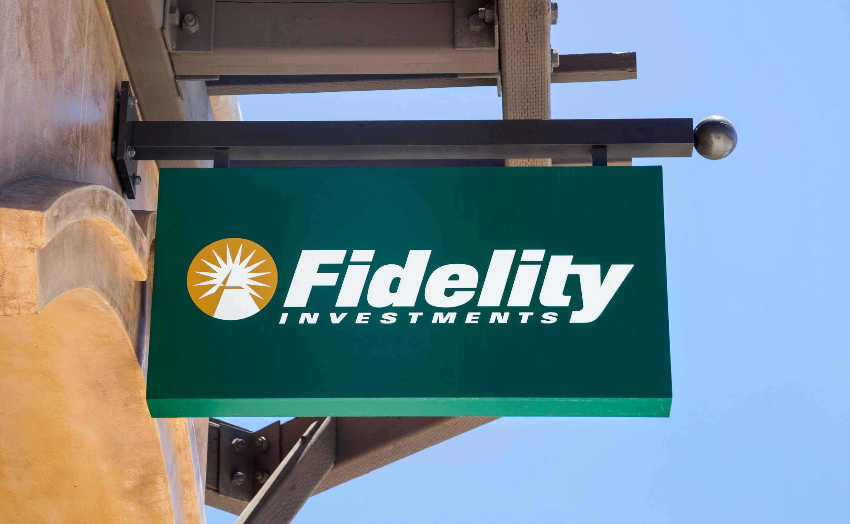 The Fidelity logo on a sign hanging against the sky