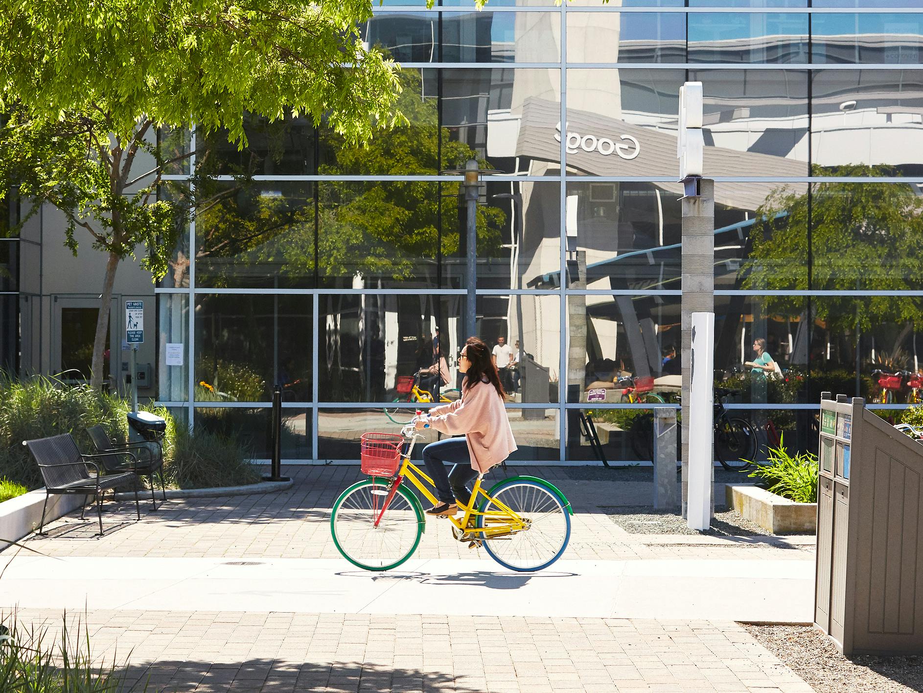 google employee riding bike on company campus
