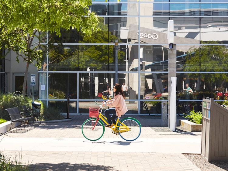google employee riding bike on company campus