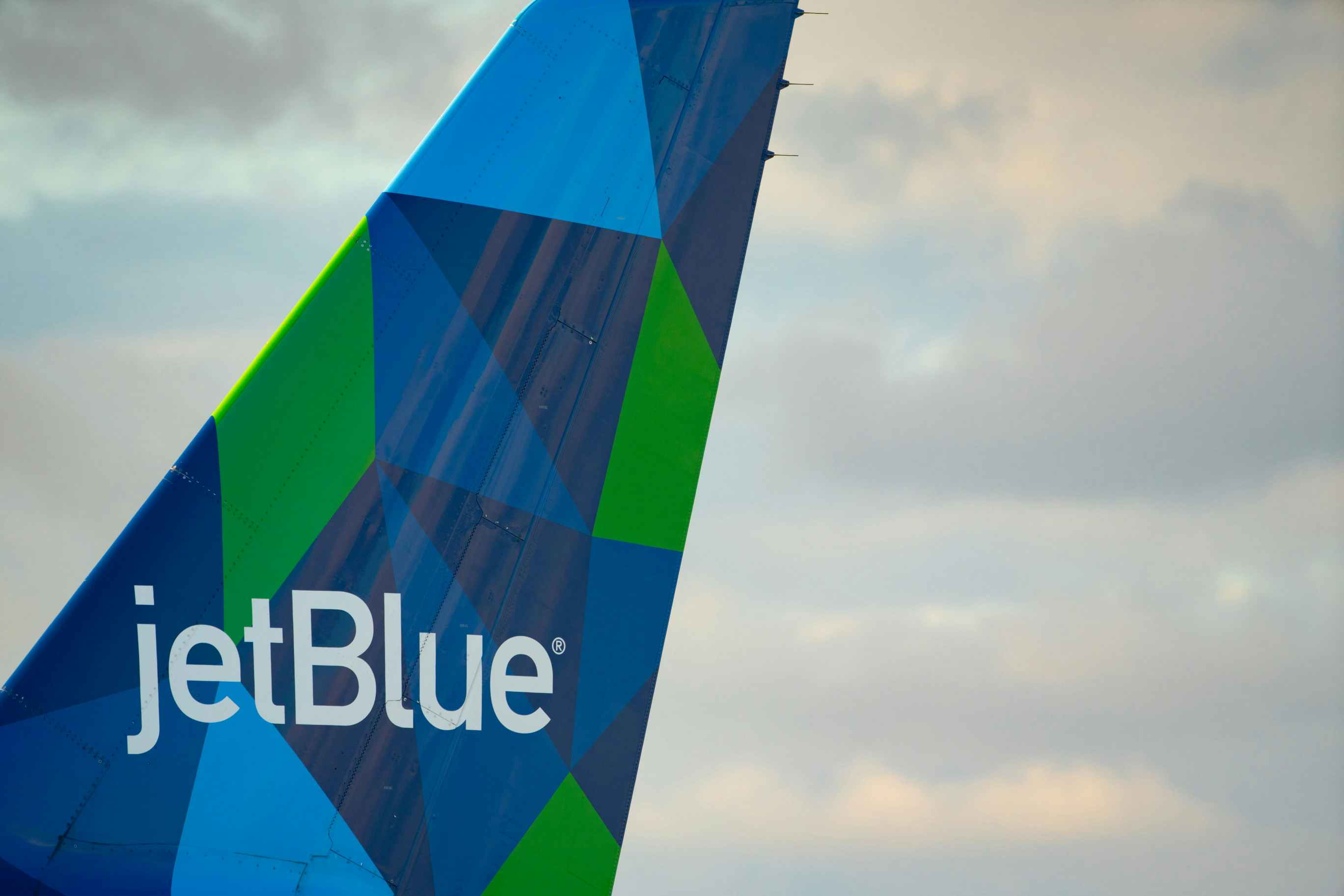 A JetBlue airplane tail with company logo