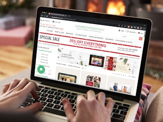 Someone using a laptop looking at the SimplyToImpress website