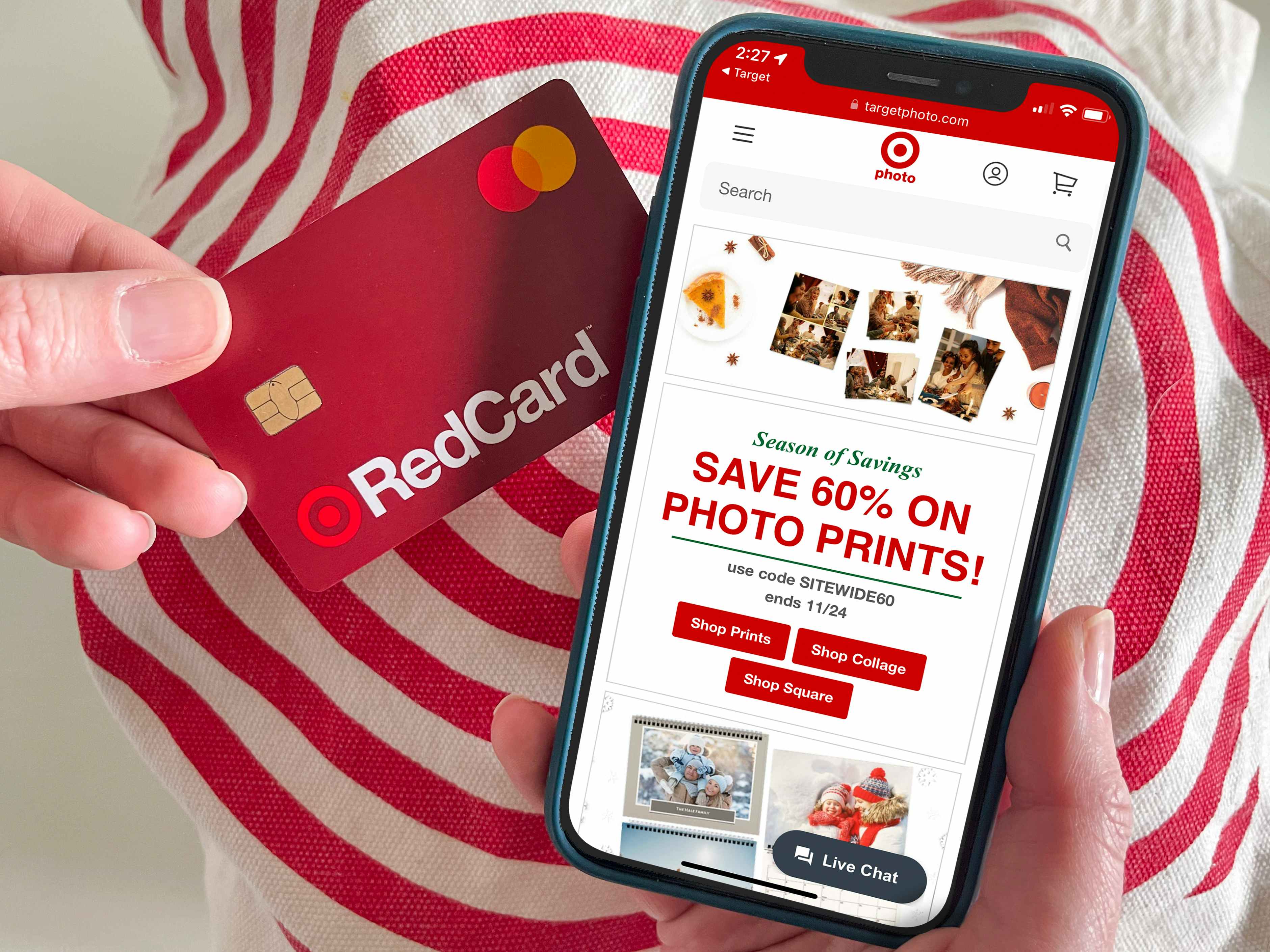 Someone looking at the Target Photo site on a cell phone and holding a Red Card