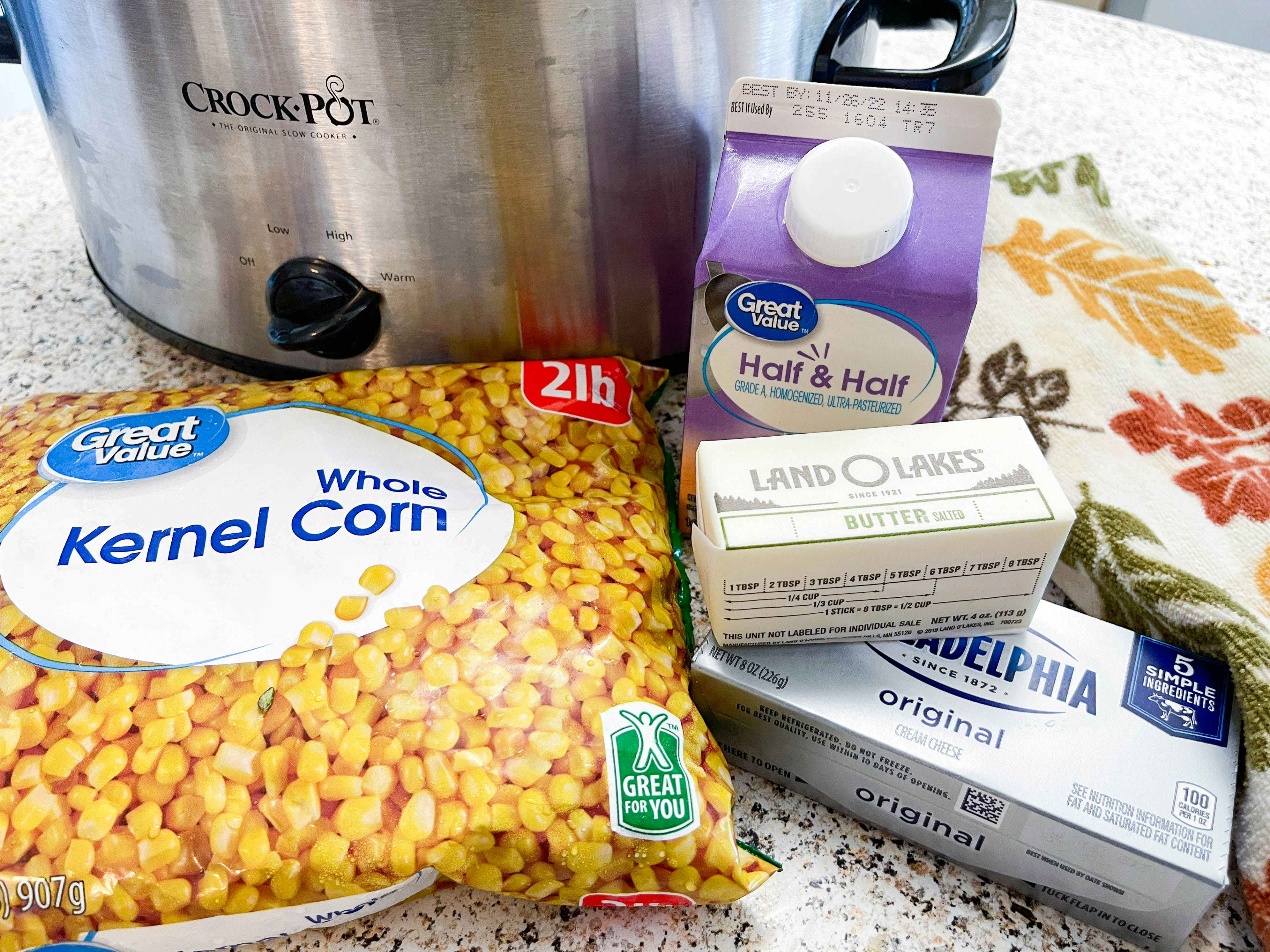 A mix of ingredients for creamed corn in front of a crock pot