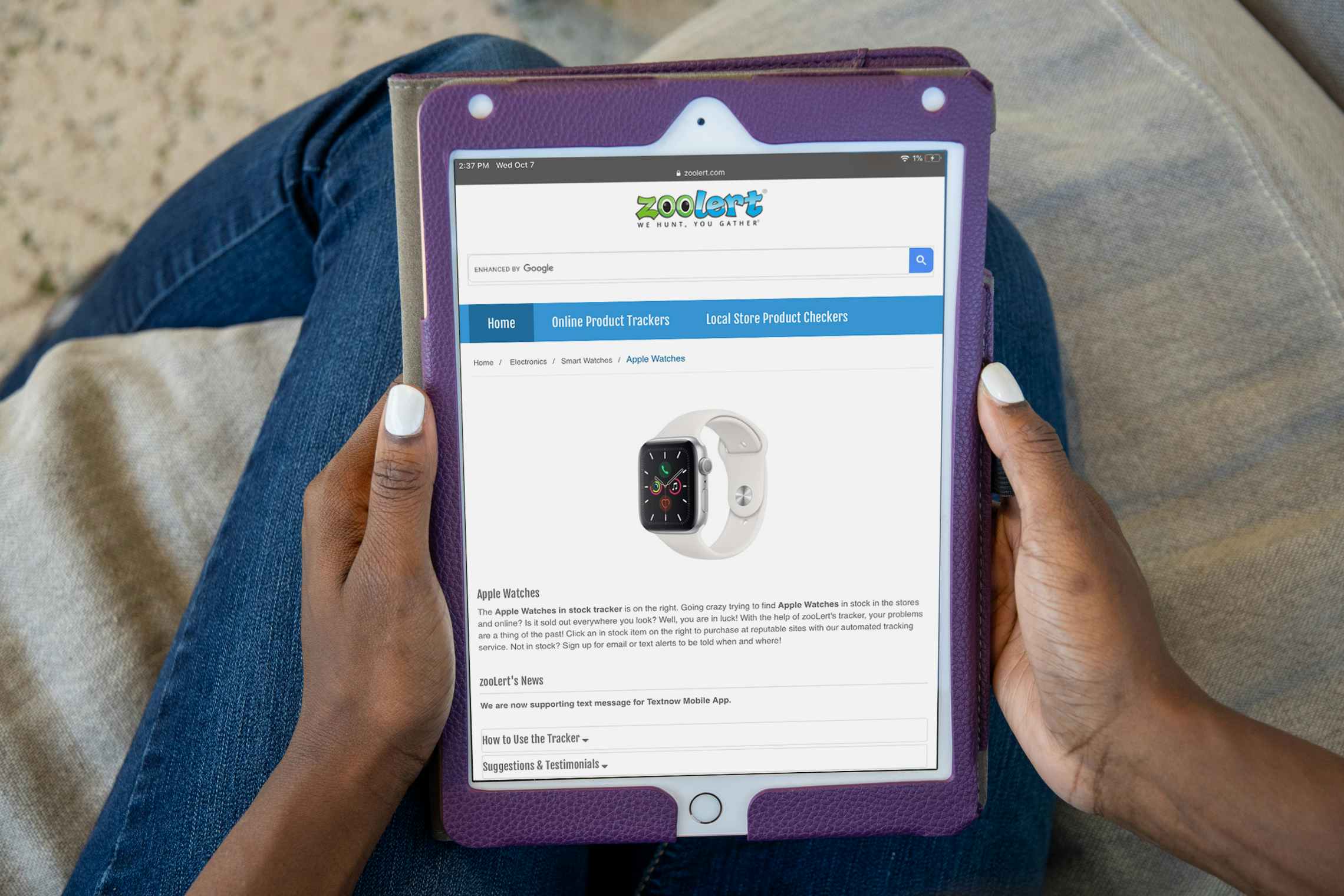 A person holding an iPad displaying the Zoolert inventory tracker webpage.