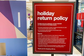 The holiday return policy sign at the front entrance.