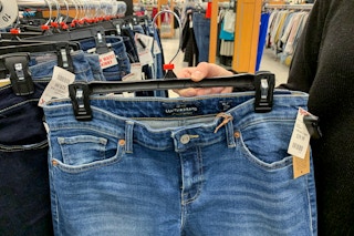 A woman holding Lucky Brand jeans.
