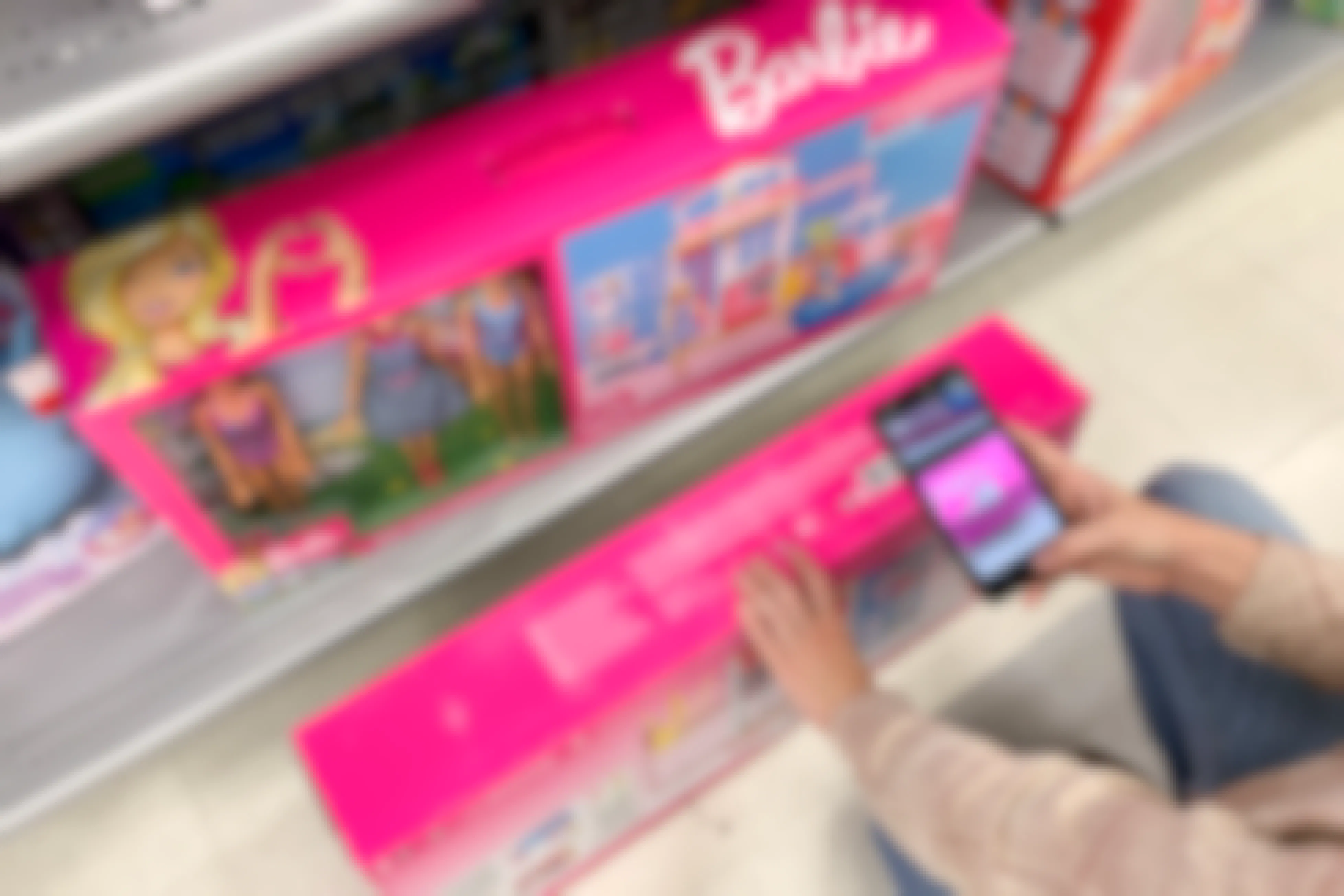A phone with the Amazon scan price comparison, scanning a Barbie play set.