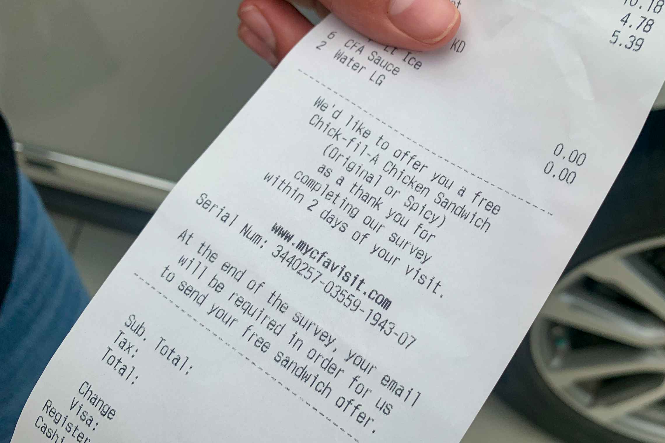 A chick-fil-a receipt with a survey for a free chicken sandwich on it.