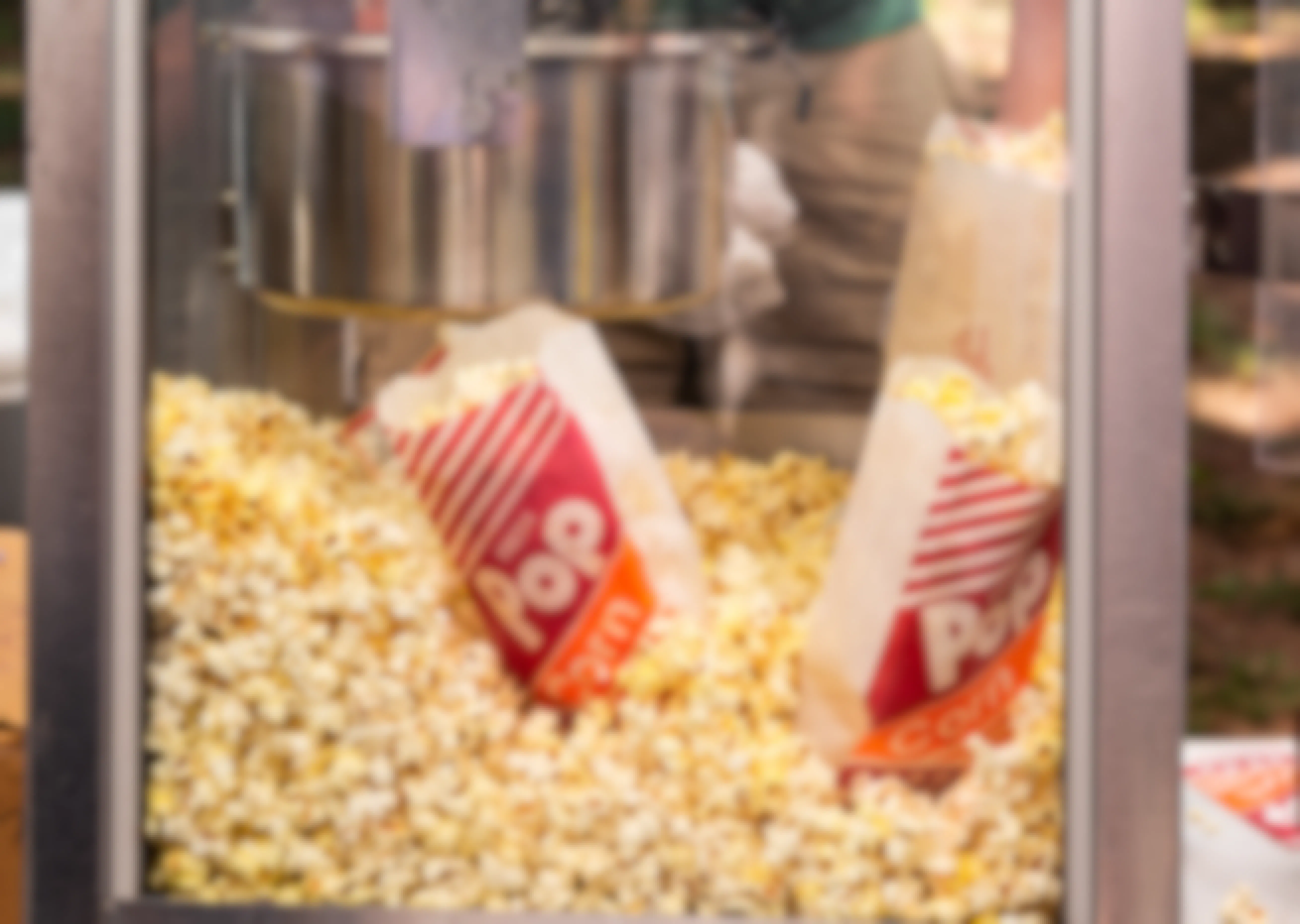 Two bags of popcorn displayed inside a popcorn machine.