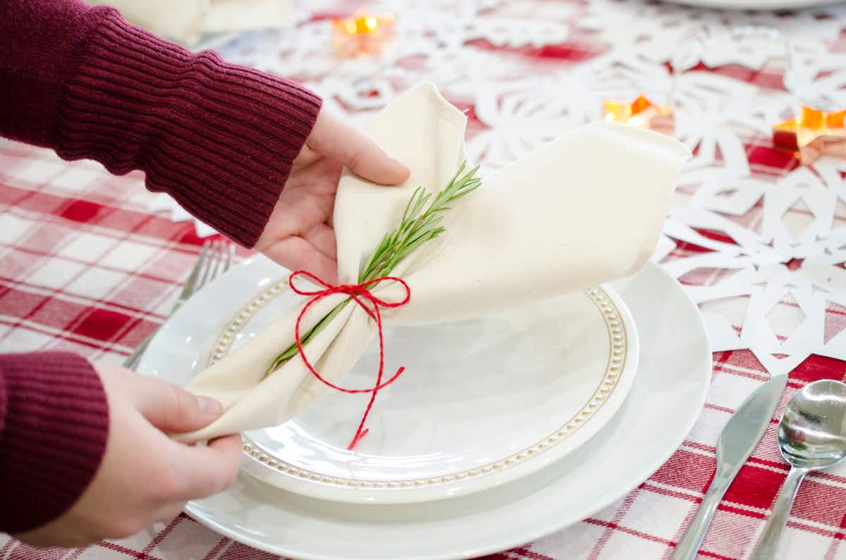 Decorate napkins and place settings with rosemary sprigs.