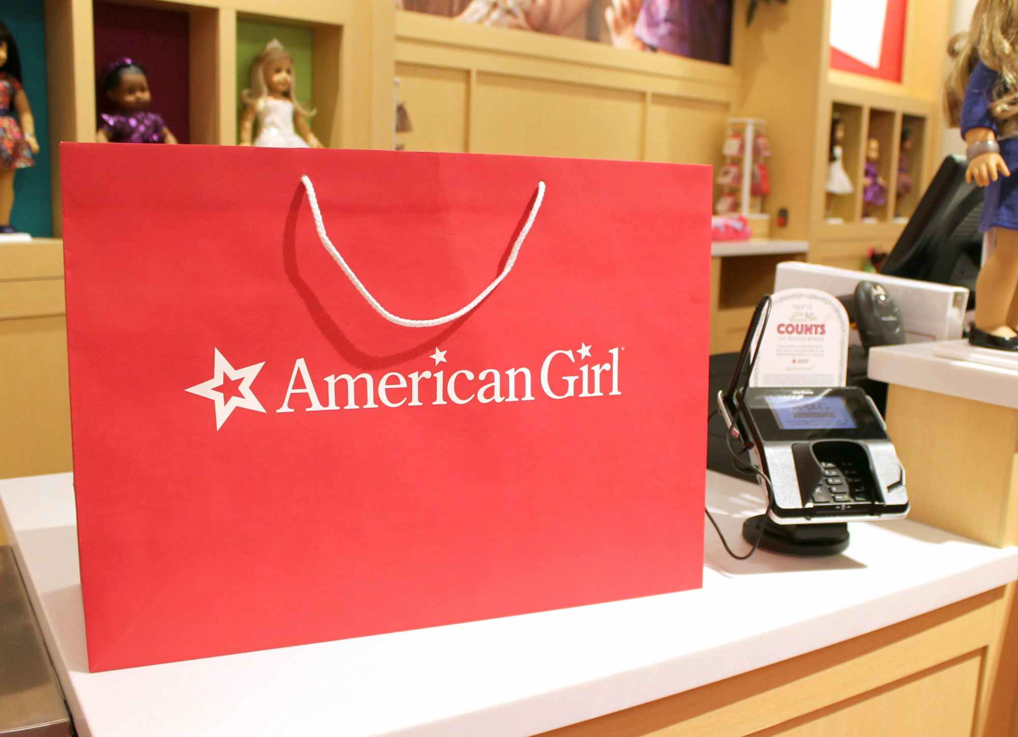 A red American Girl shopping bag on a counter