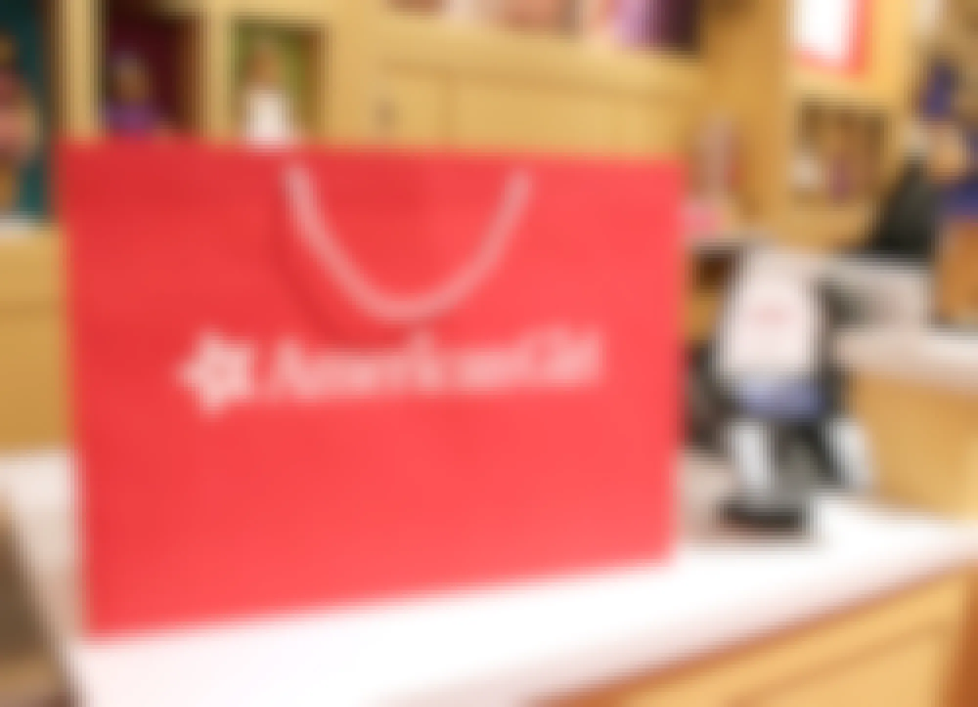 A red American Girl shopping bag on a counter