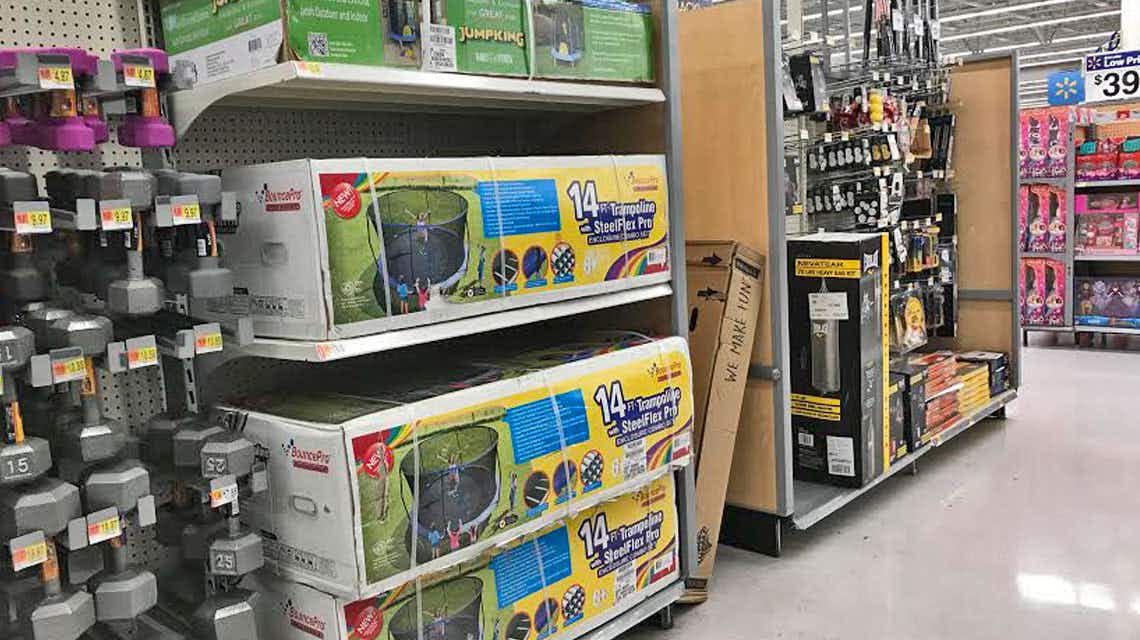 Boxed trampolines for sale on a Walmart shelf.