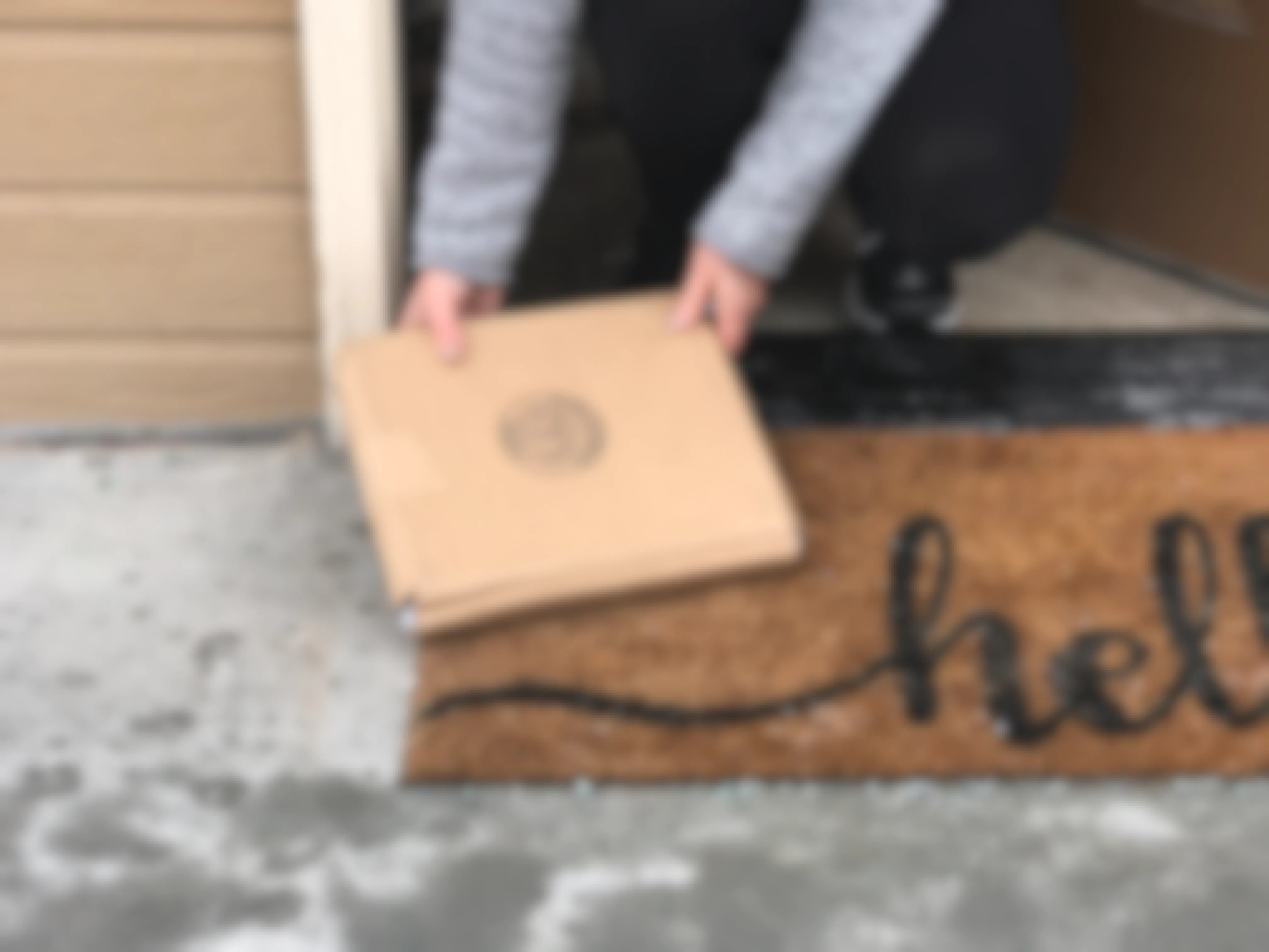 Woman picking up a package left at her doorstep