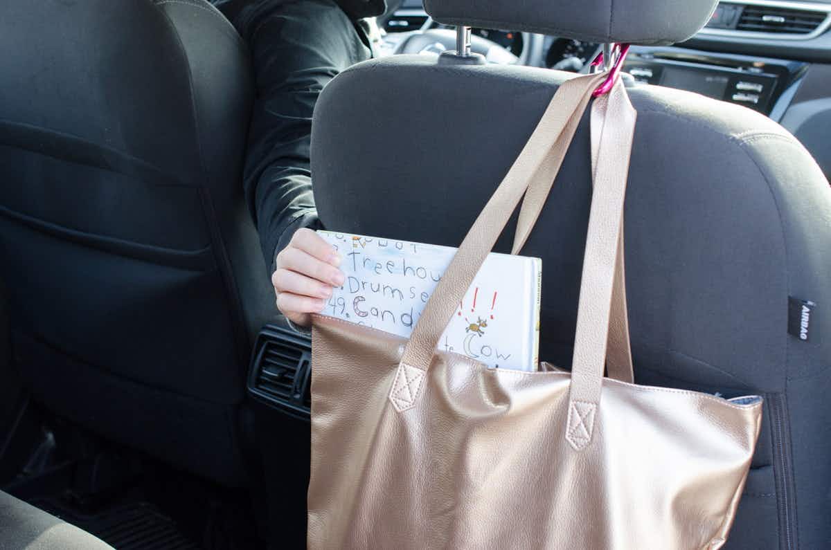Use a carabiner clip to hang kids' bags from your carseat.
