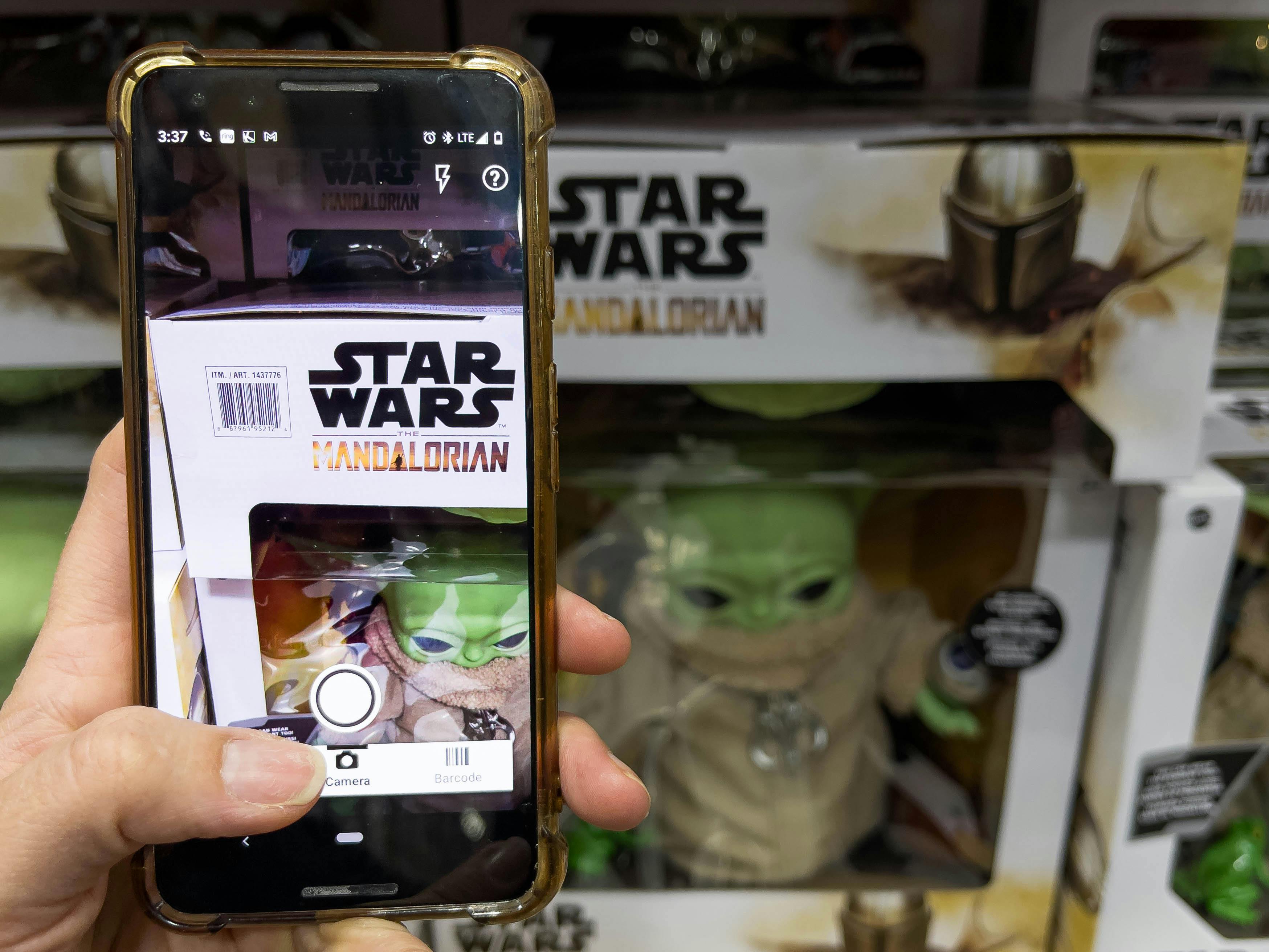 A person scanning a Star Wars Mandalorian toy with the amazon app