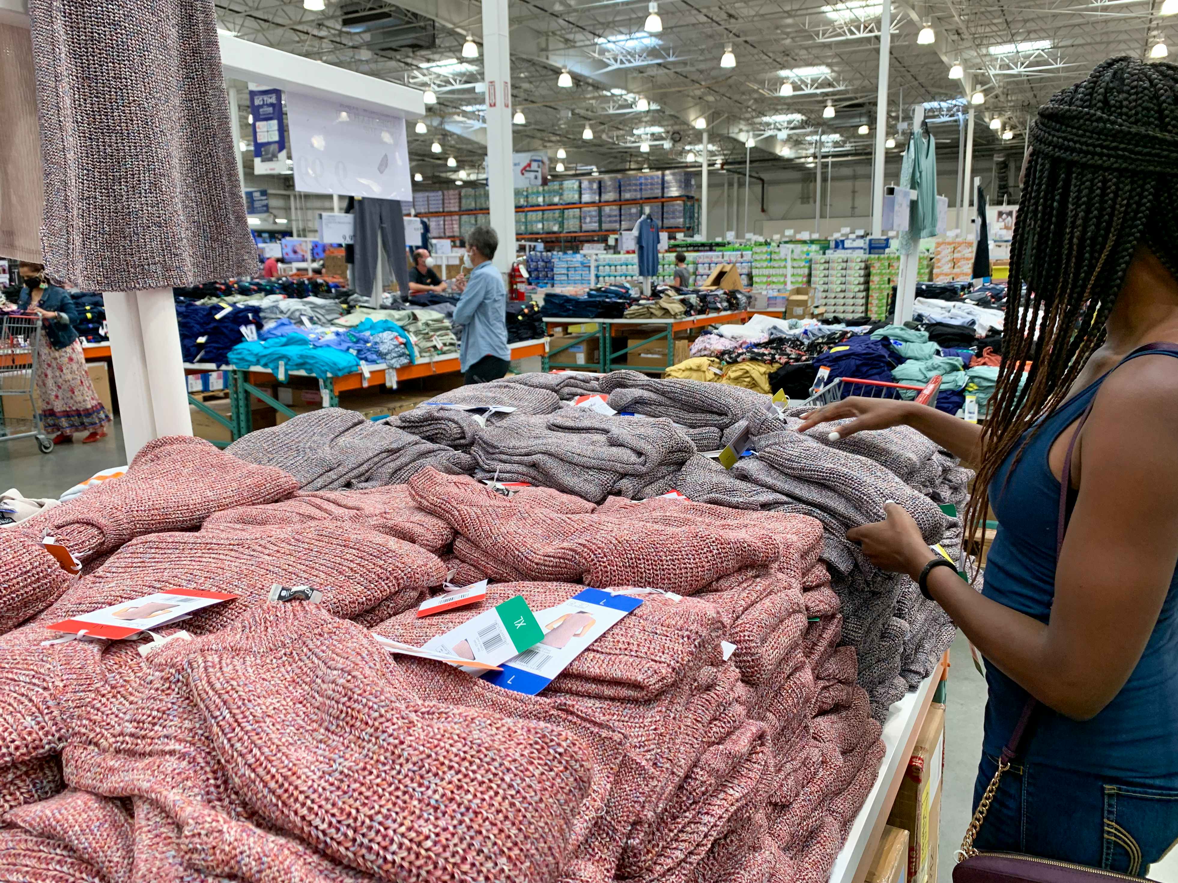 A woman looking at clothing inside Costco.