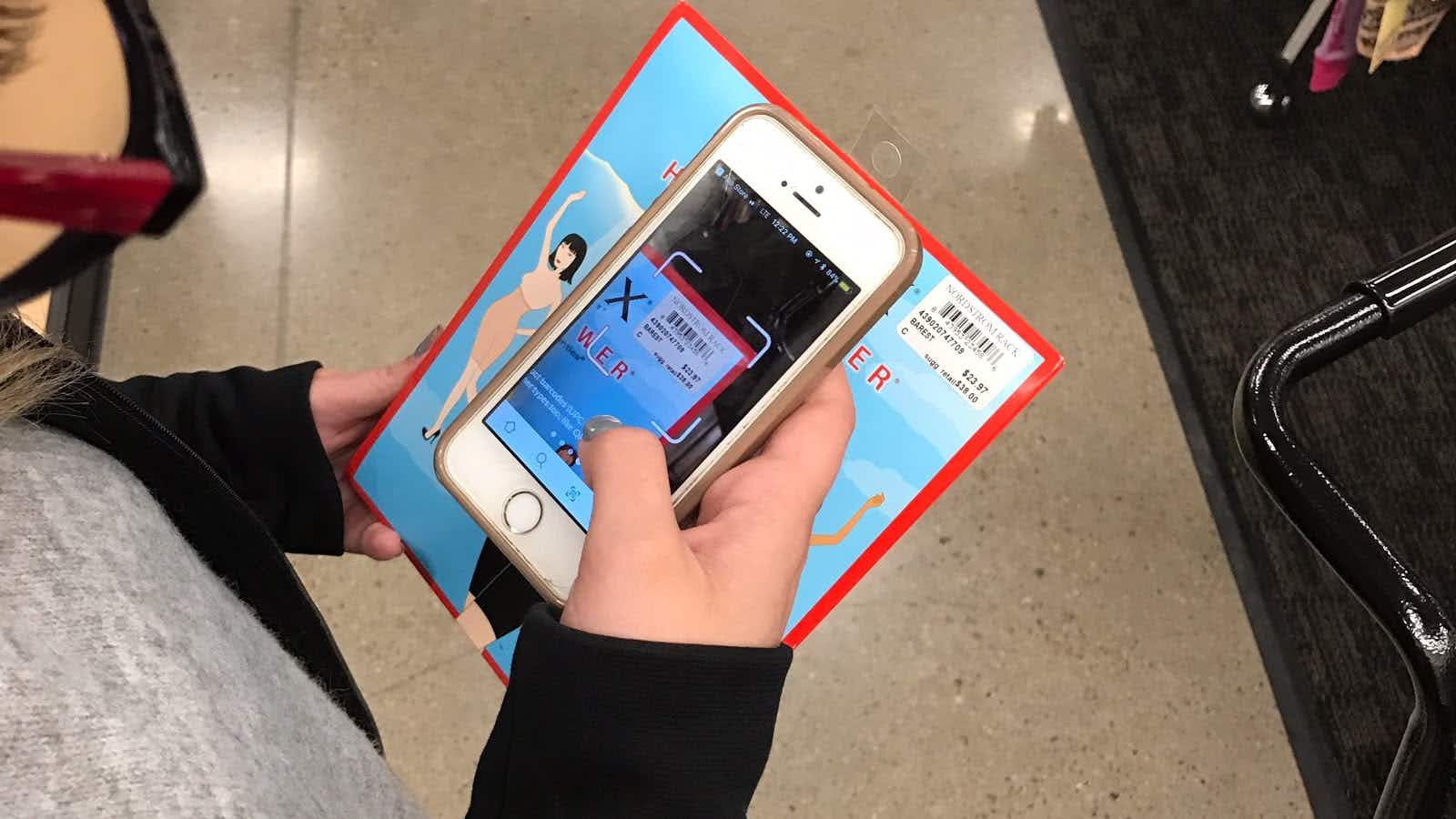 A person scanning an item at Nordstrom rack to price check it.