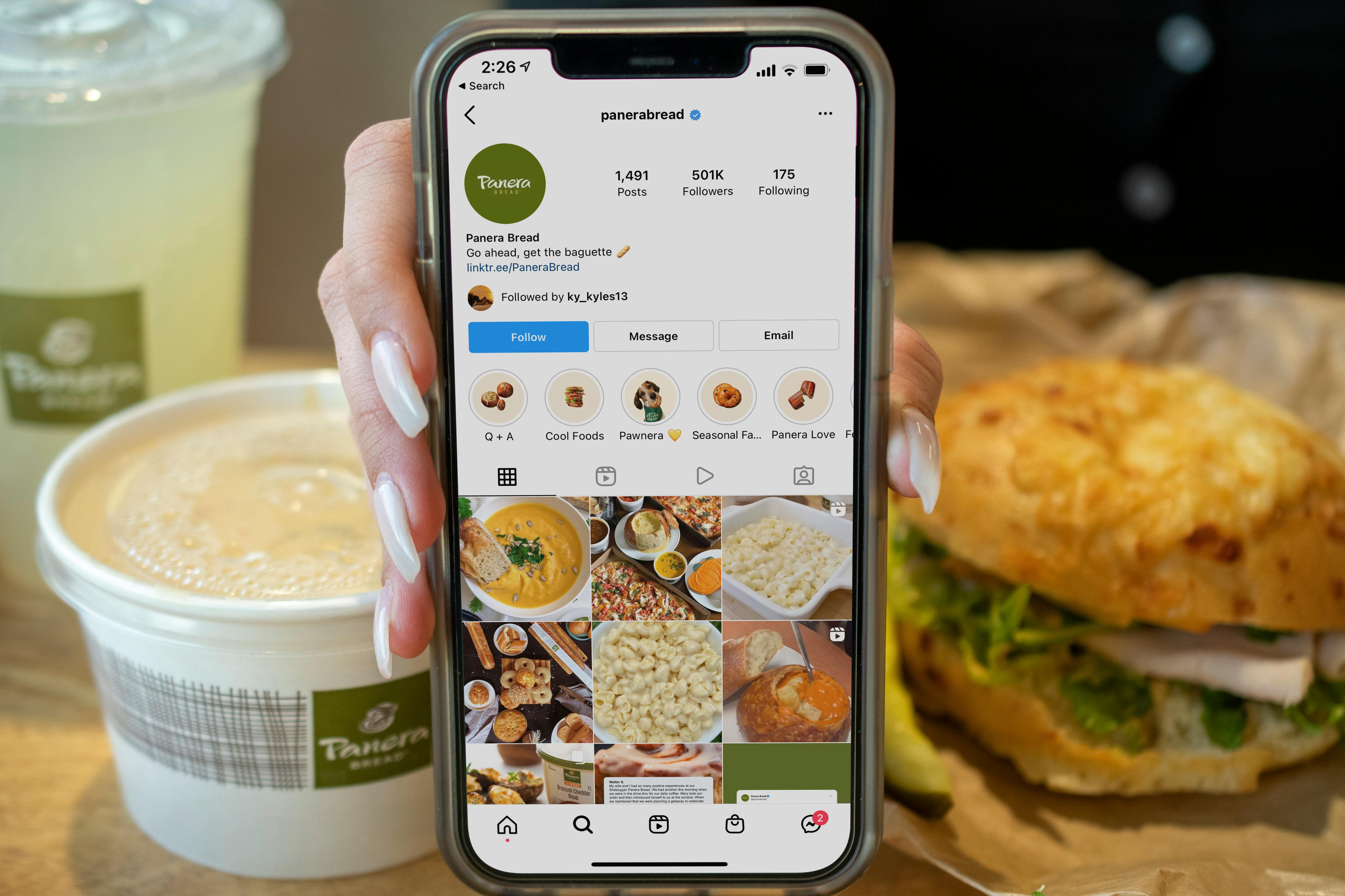 Panera's instagram page on a cell phone with a panera meal in the background