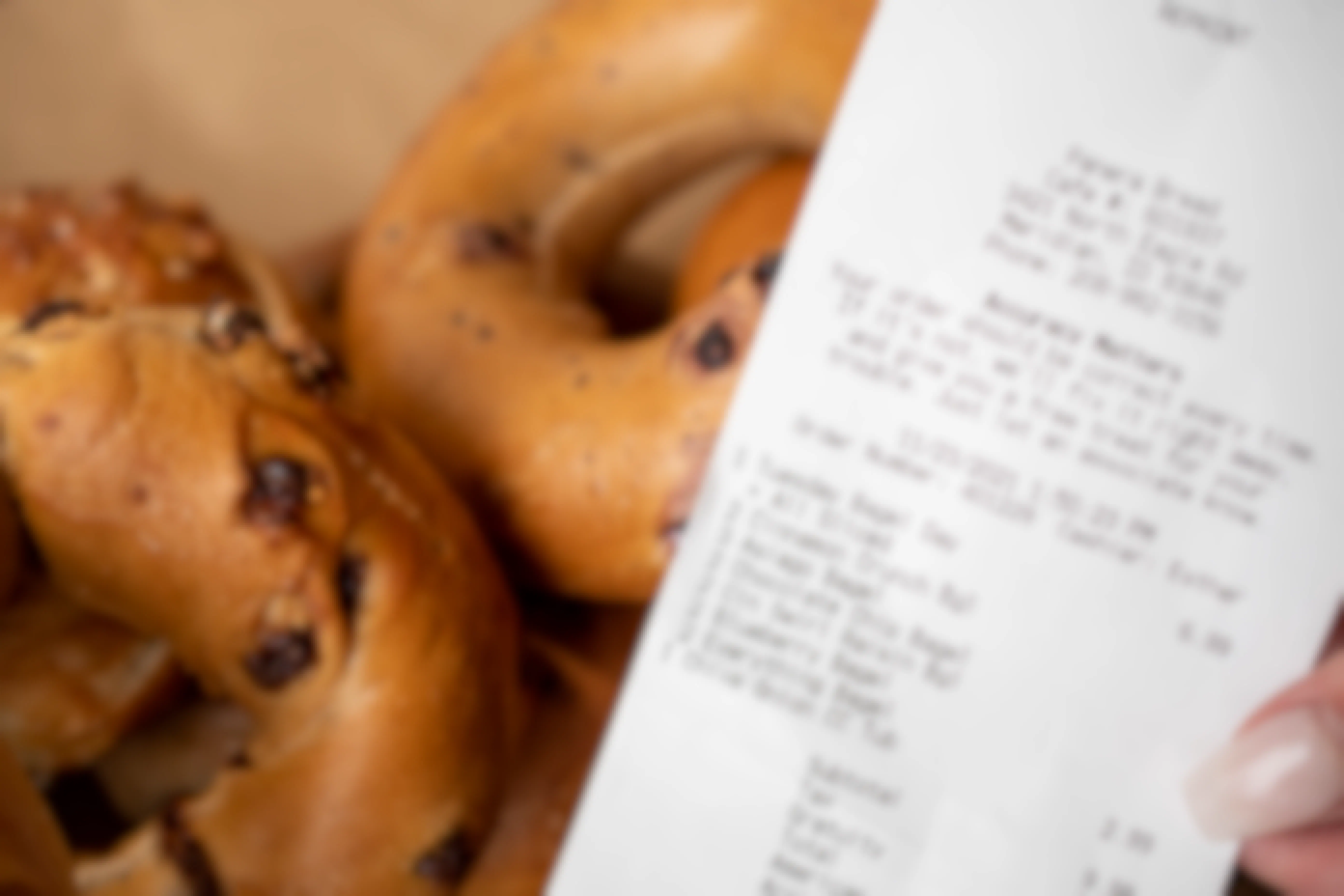 A receipt next to a stack of bagels