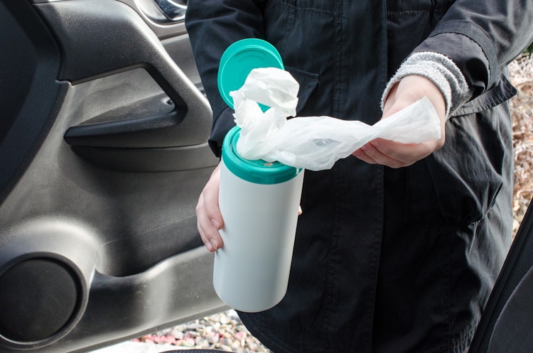 Reuse a wipes container to store and easily dispense plastic bags.
