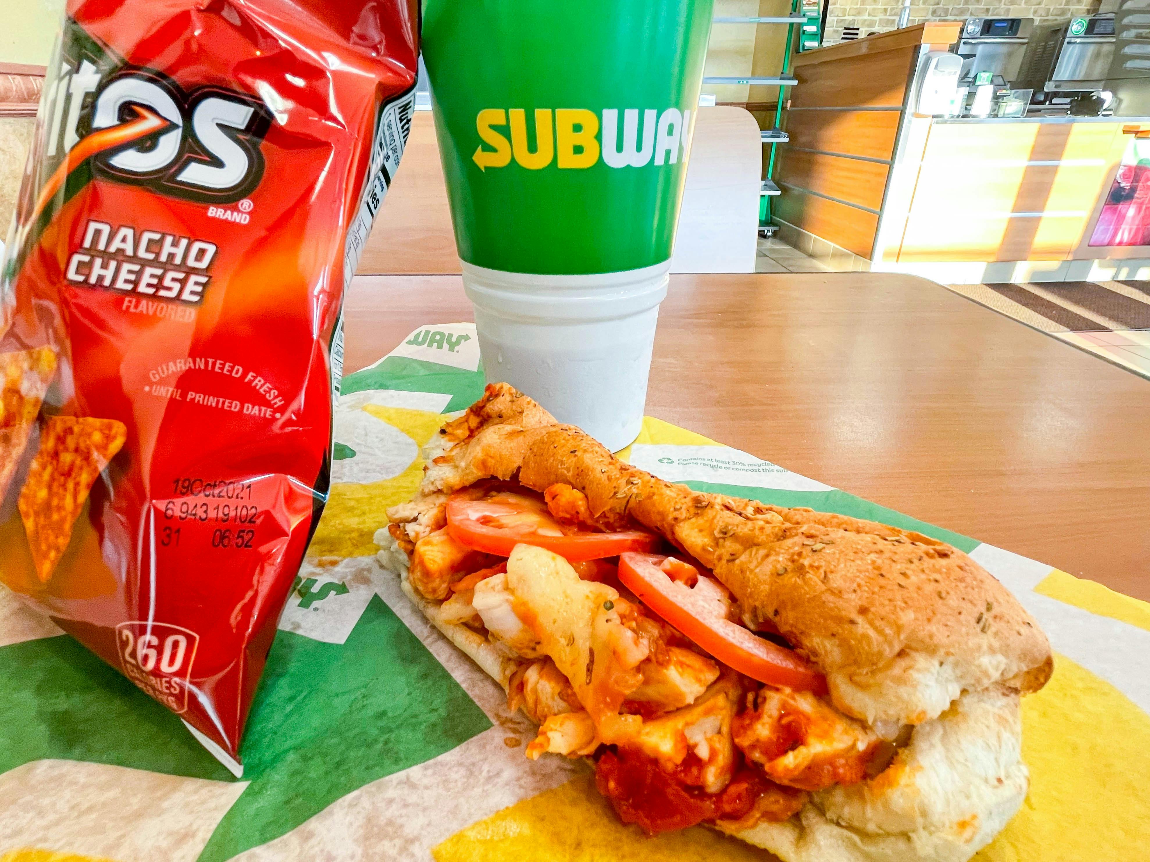 subway sub with chips and a drink