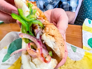 close up of sub with toasted onions and peppers