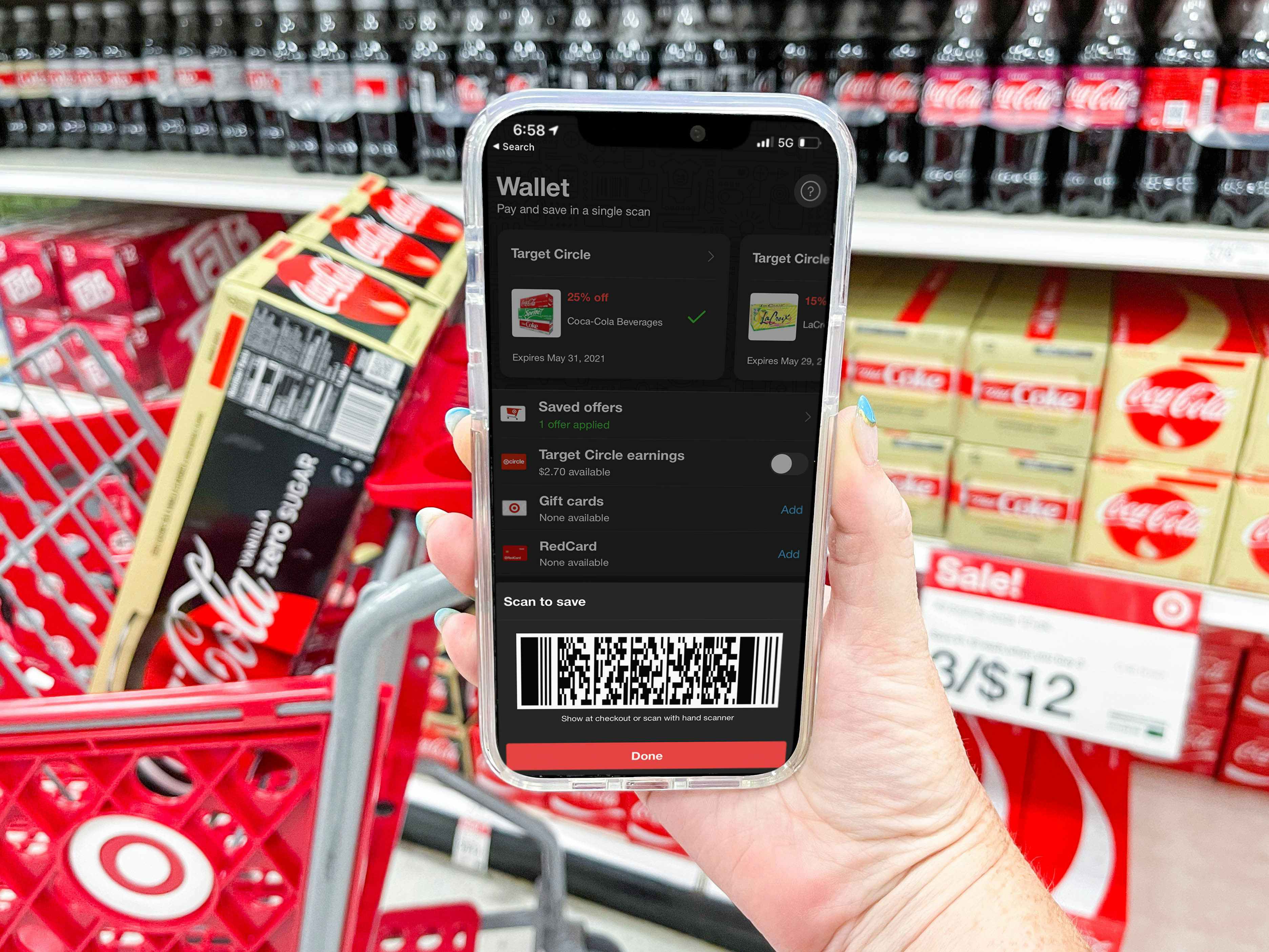 hand holding cellphone in soda aisle with scanning app
