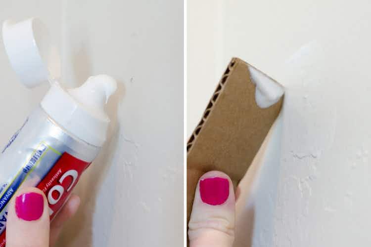 Someone filling small holes in drywall with toothpaste.