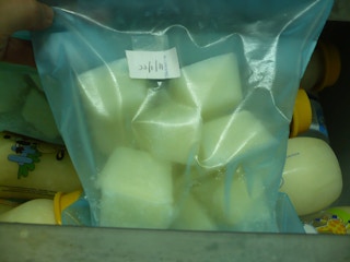 Pour milk into ice cube trays