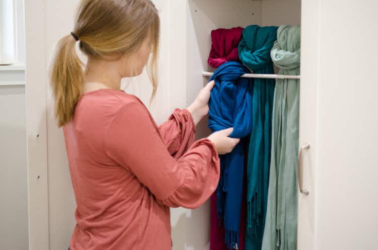 Use a tension rod to hang and organize scarves.