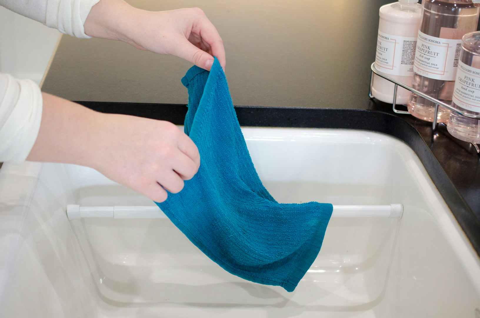 Hang wet dish towels in the sink