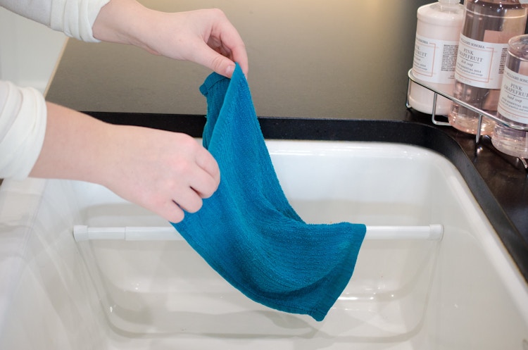 Hang wet dish towels in the sink