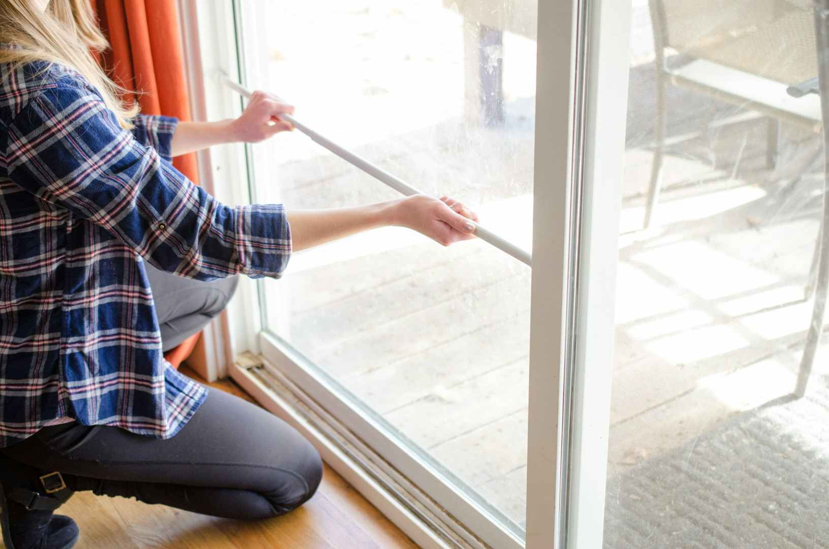 Prevent kids from getting out or someone from breaking in by placing a tension rod in your sliding door