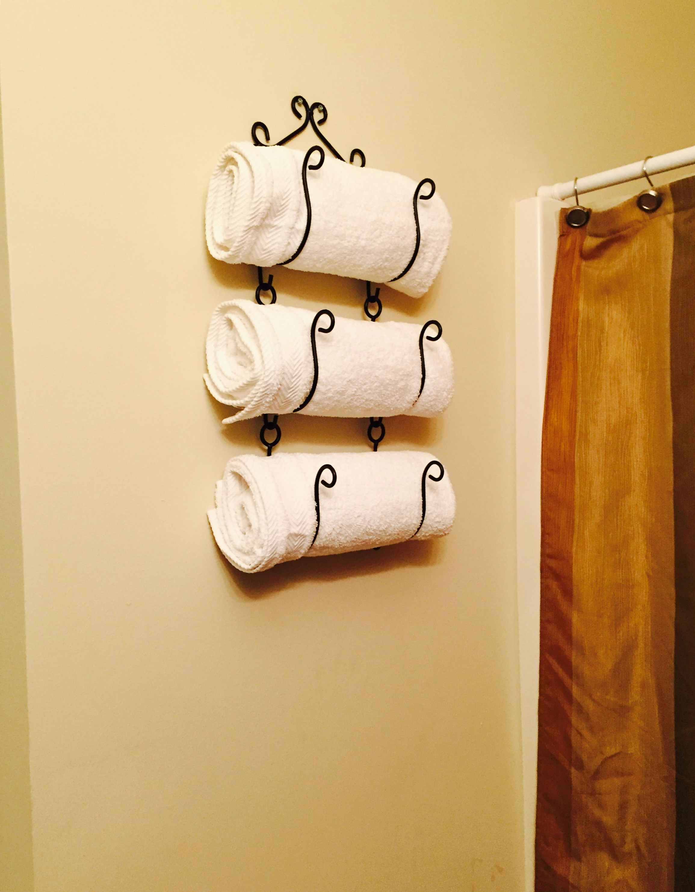 Repurpose a wine rack and use it to store towels.