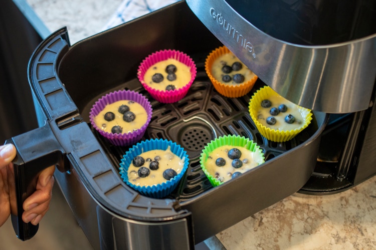 muffin batter in silicone muffin cups, in an air fryer 
